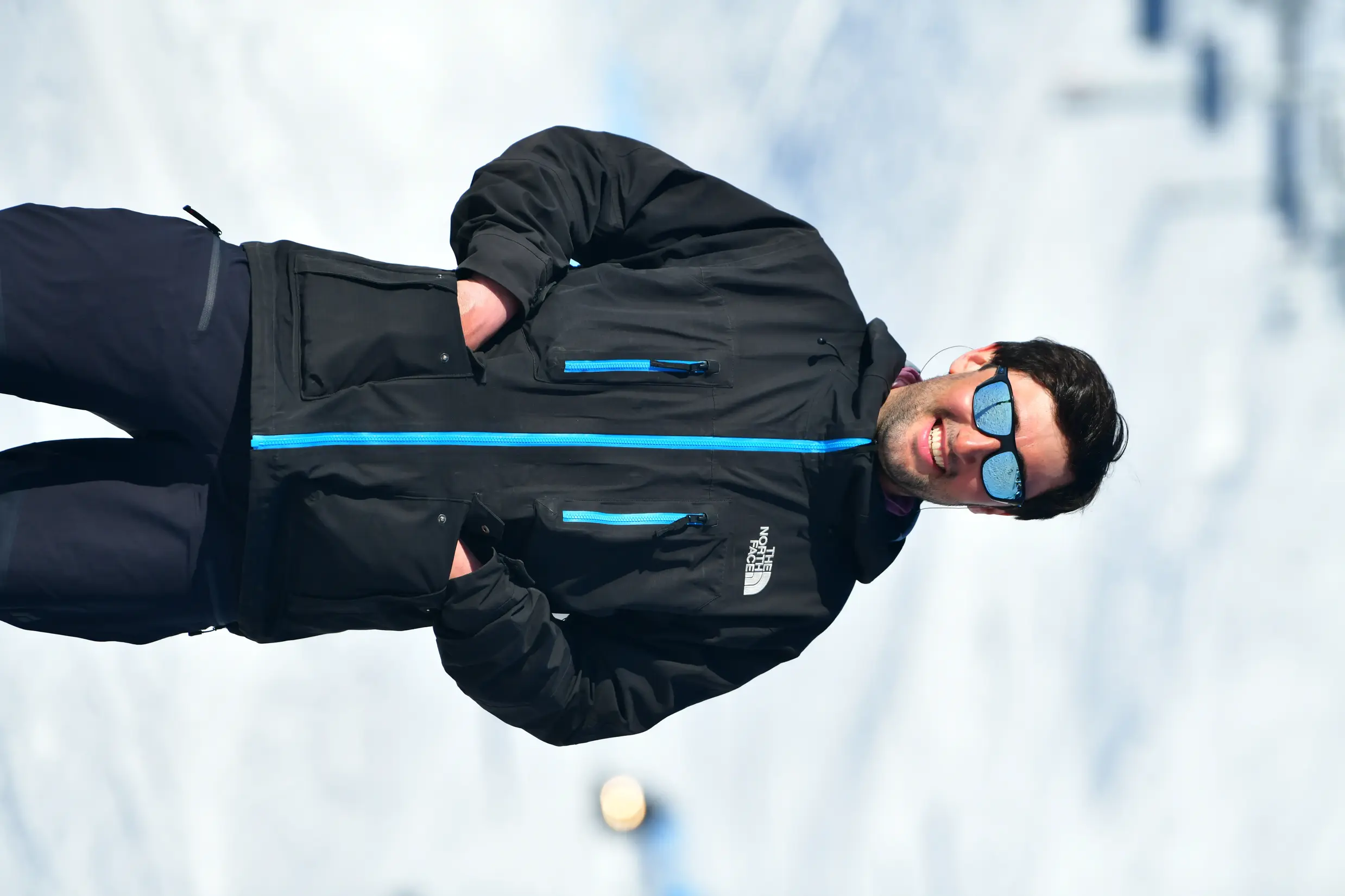 Portrait of pilot Sagina with snowy mountains behind him